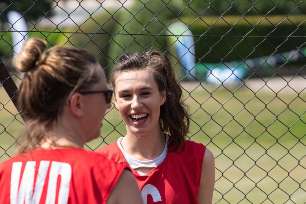 Happy Netball Players Smiling on an Outdoor Netball Court