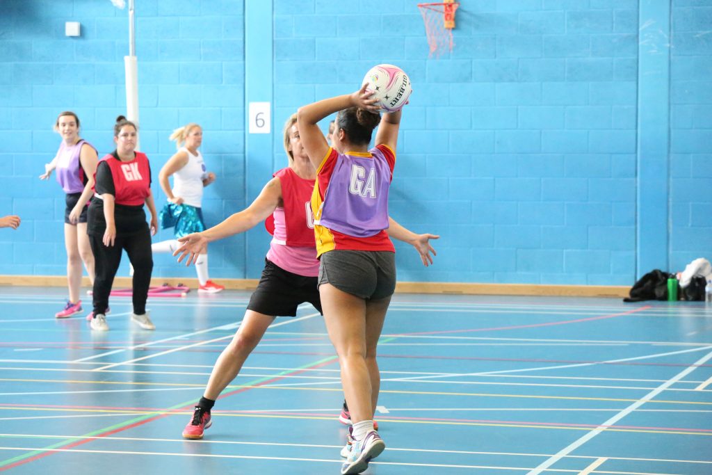 Indoor Netball League Players Playing Netball