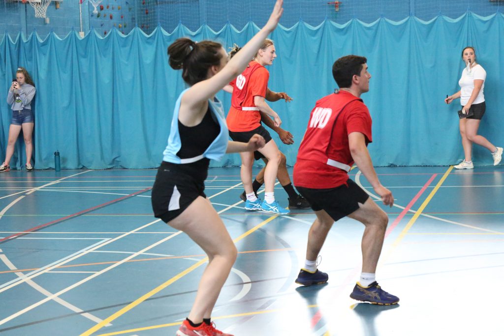 A Group of Mixed Netball Players on an Indoor Netball Court